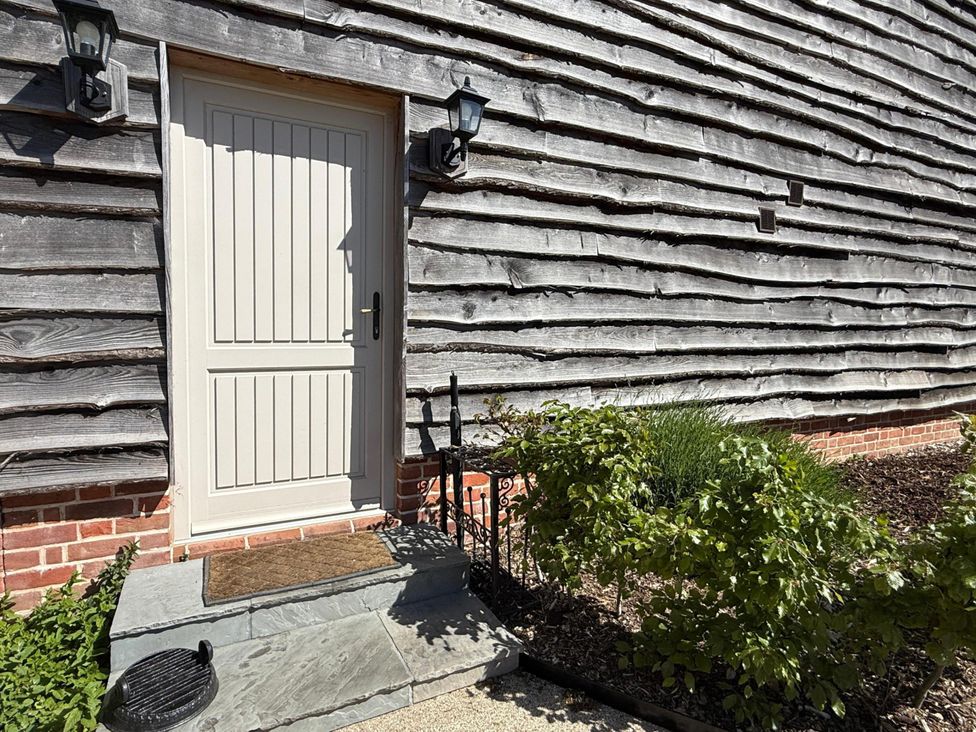 An entrance door with stone steps and plants at Charming Barn Annex with Stables New Forest Escape 