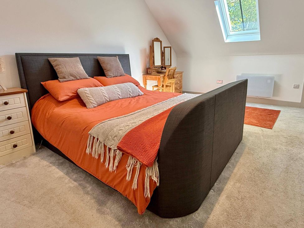 A bedroom with a bed and dressing table at Charming Barn Annex with Stables New Forest Escape