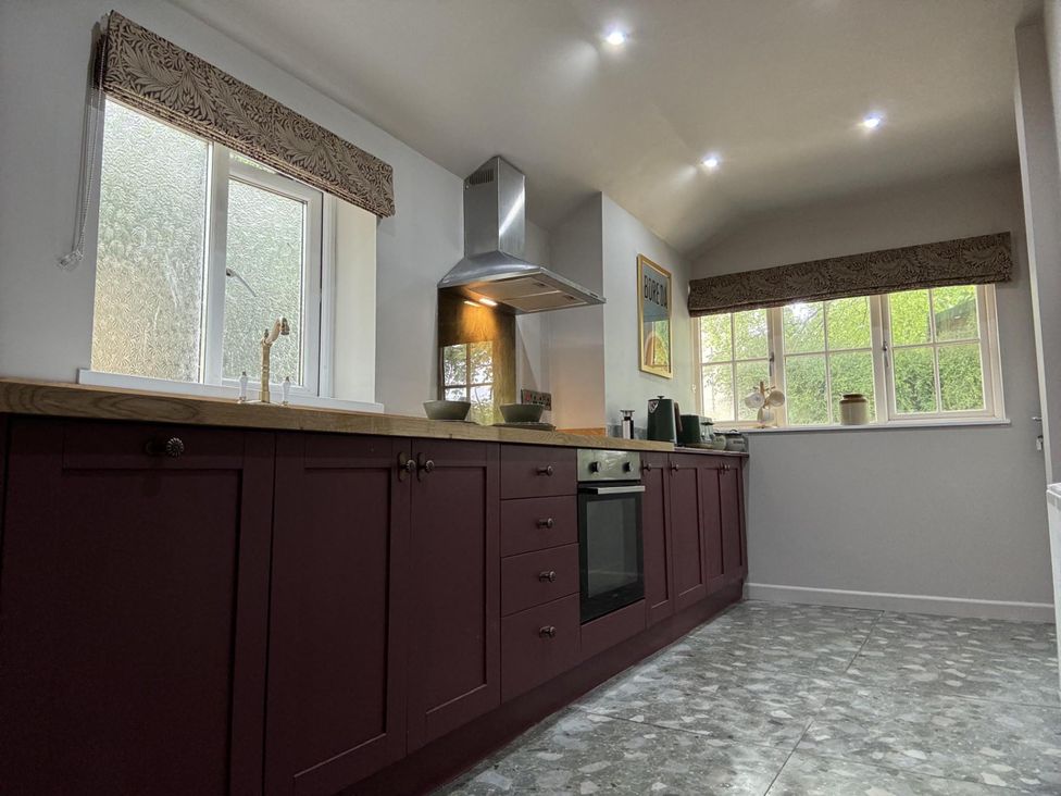 A kitchen with cabinets and a window at Llysawelon 2-Bed Cottage, Sleeps 5, Pets Ok Llysawelon near Llansteffan