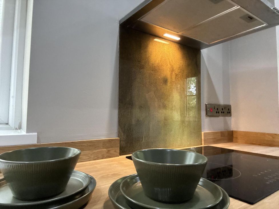 A kitchen with bowls and plates on the countertop at Llysawelon 2-Bed Cottage, Sleeps 5, Pets Ok, Llysawelon near Llansteffan