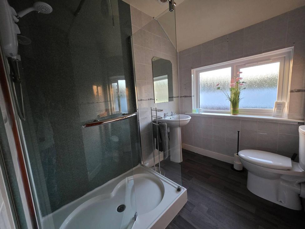 A bathroom with a shower, sink, and toilet at Highlands - River View - Apt - Sleeps 4 - Garden in Garve near Strathpeffer