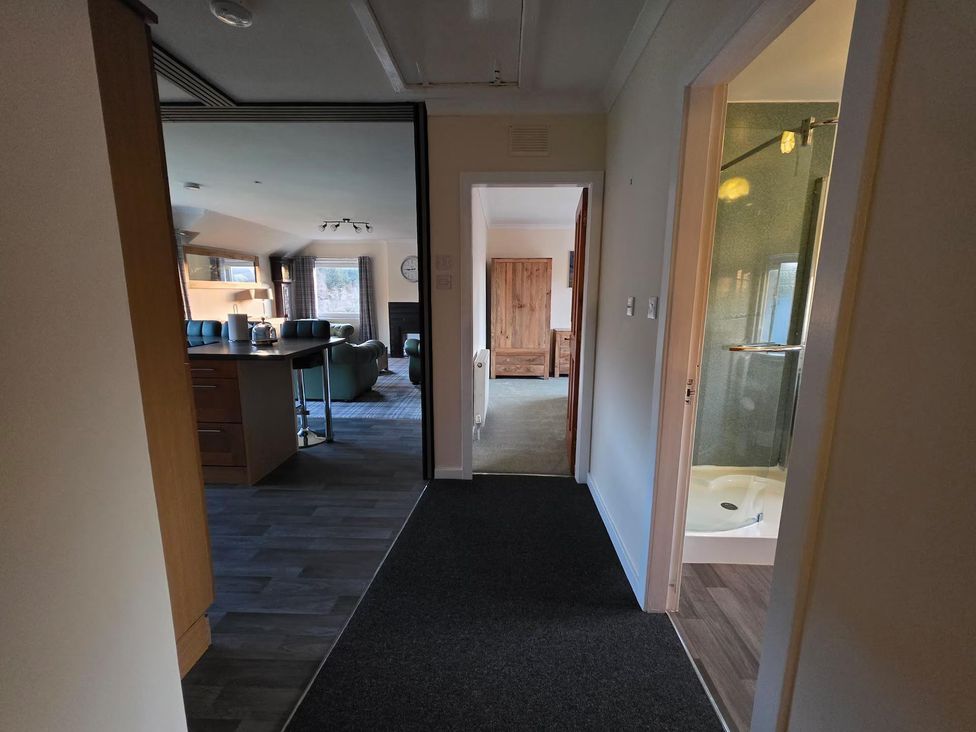 A hallway leading to a kitchen and living room at Highlands - River View - Apt - Sleeps 4 - Garden in Garve near Strathpeffer