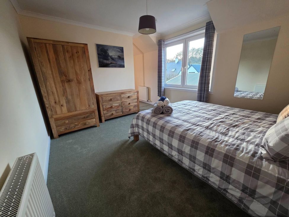 A bedroom with a bed, wardrobe and dresser at Highlands - River View - Apt - Sleeps 4 - Garden Garve near Strathpeffer