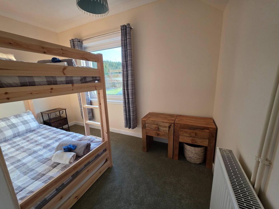 A bedroom with a bunk bed and wooden tables at Highlands - River View - Apt - Sleeps 4 - Garden in Garve near Strathpeffer