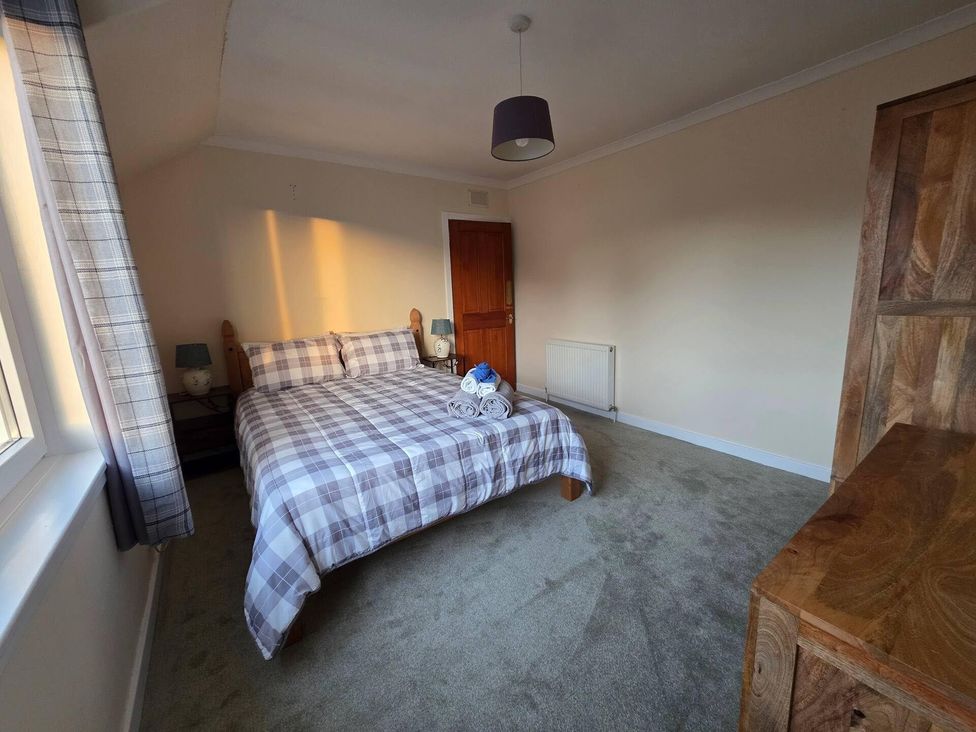 A bedroom with a bed and bedside tables at Highlands - River View - Apt - Sleeps 4 - Garden in Garve near Strathpeffer