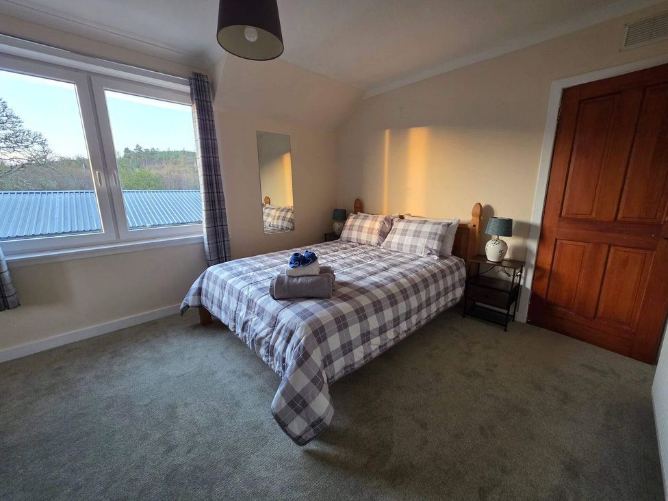 A bedroom with a bed and bedside table at Highlands - River View - Apt - Sleeps 4 - Garden Garve near Strathpeffer