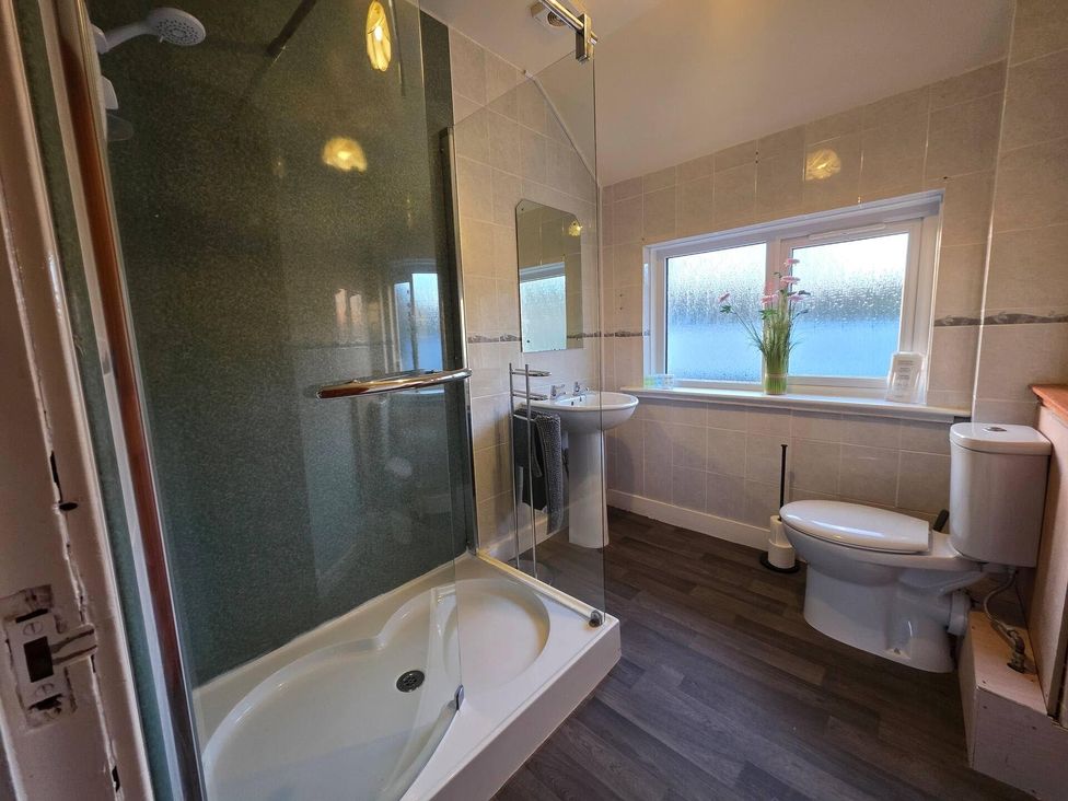 A bathroom with a shower, toilet, and sink at Highlands - River View - Apt - Sleeps 4 - Garden Garve near Strathpeffer