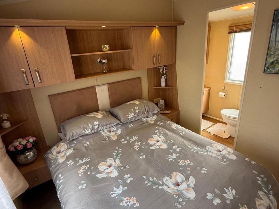 A bedroom with a bed and attached bathroom at 2-Bed Caravan, Sleeps 6 w/ Parking, No Pass Needed