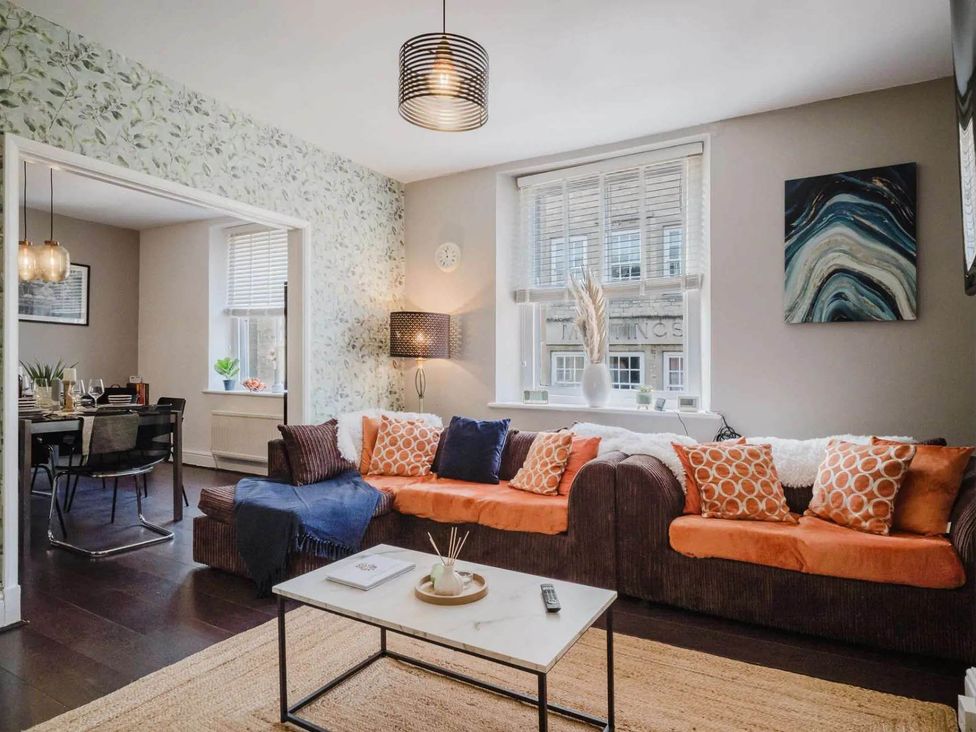 A living room with a sofa and coffee table at Licatas Apartment Cirencester Cotswolds Sleeps 6