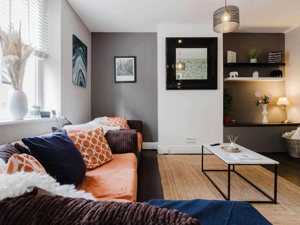 A living room with a sofa and coffee table at Licatas Apartment Cirencester Cotswolds Sleeps 6