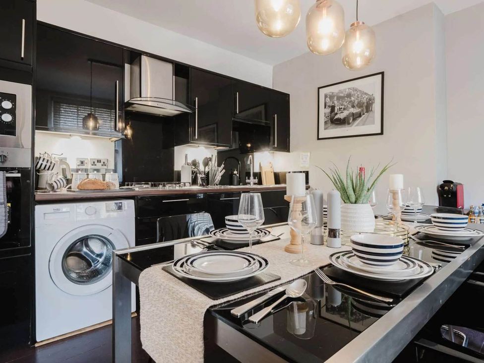 A kitchen with dining table set at Licatas Apartment Cirencester Cotswolds Sleeps 6