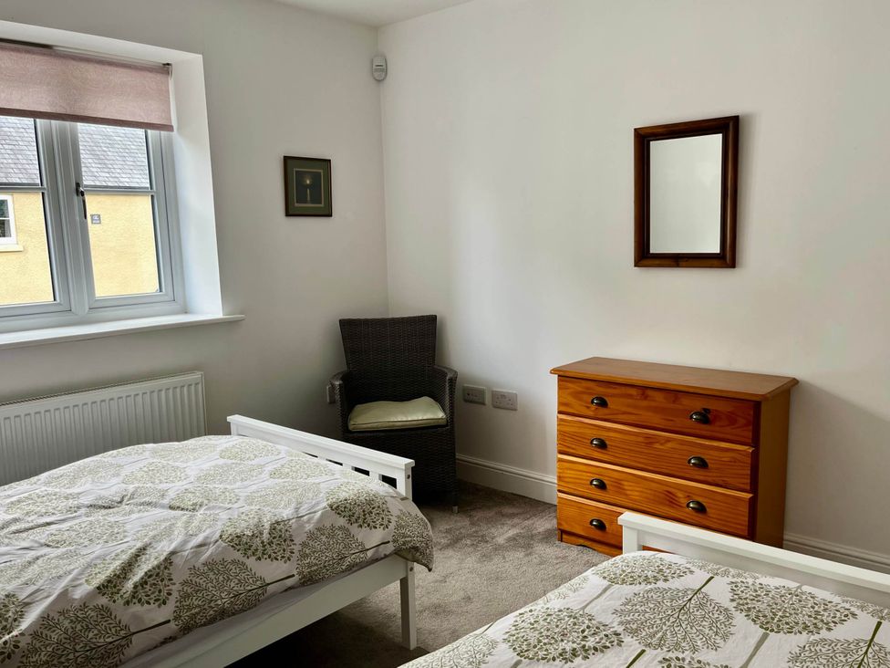 A bedroom with two beds and a dressing table at Apartment Sleeps 4 with Parking Chagford