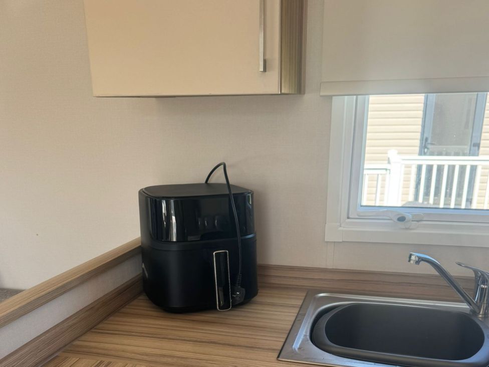 A kitchen with an air fryer and a sink at Caravan - Sleeps 6 - Parking in Lossiemouth