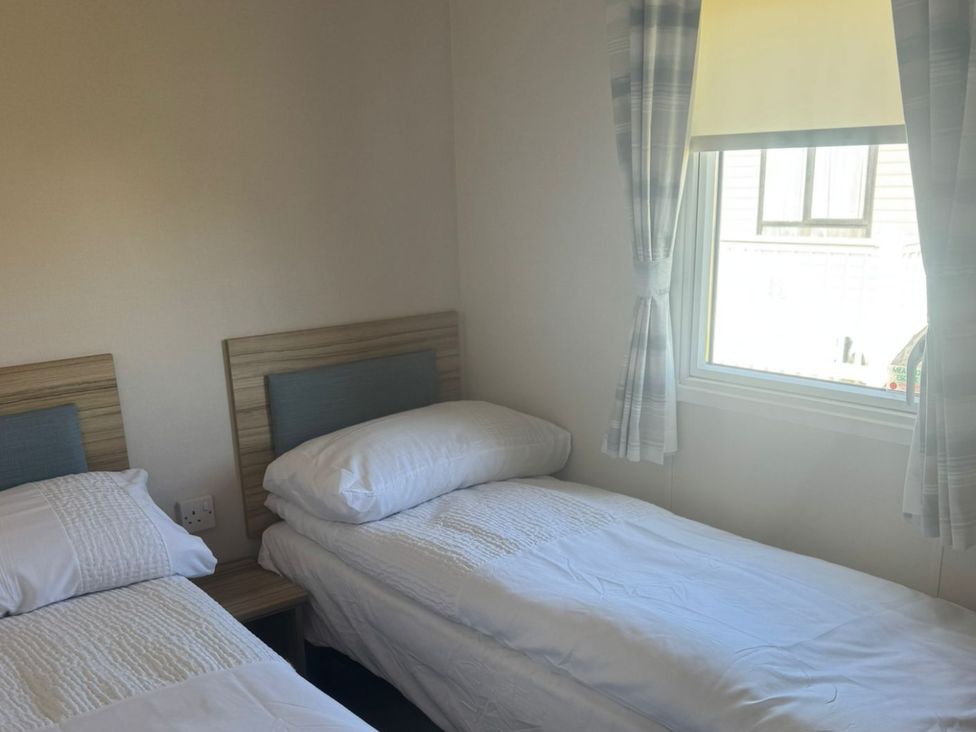 A bedroom with two single beds at Caravan - Sleeps 6 - Parking in Lossiemouth