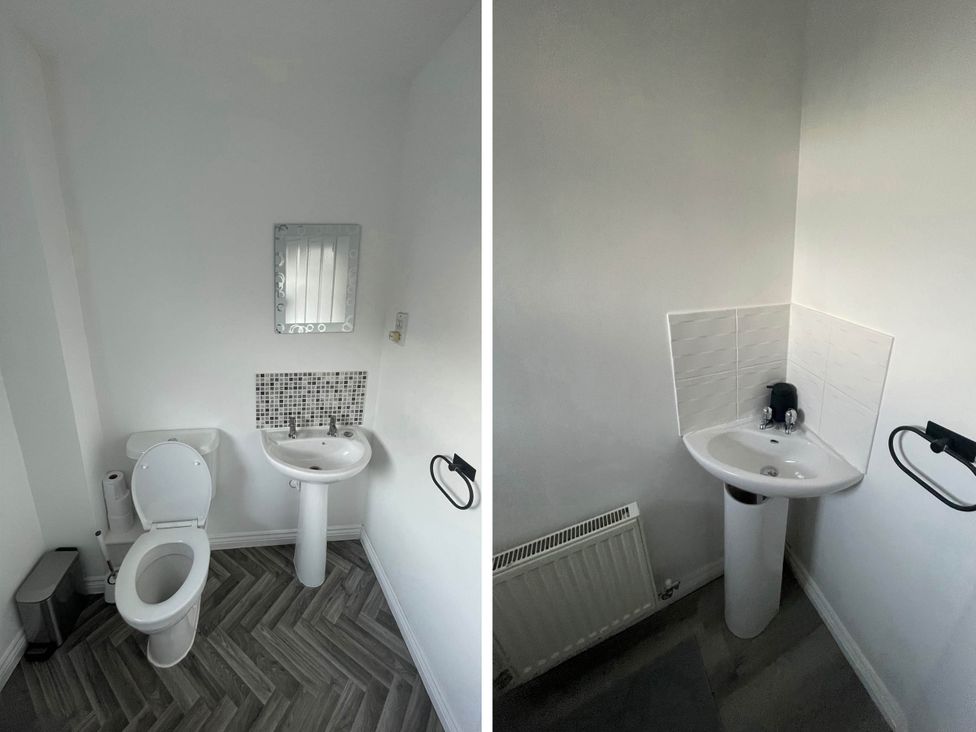 A bathroom with a toilet and sink at House Sleeps 5 with Garden and Parking