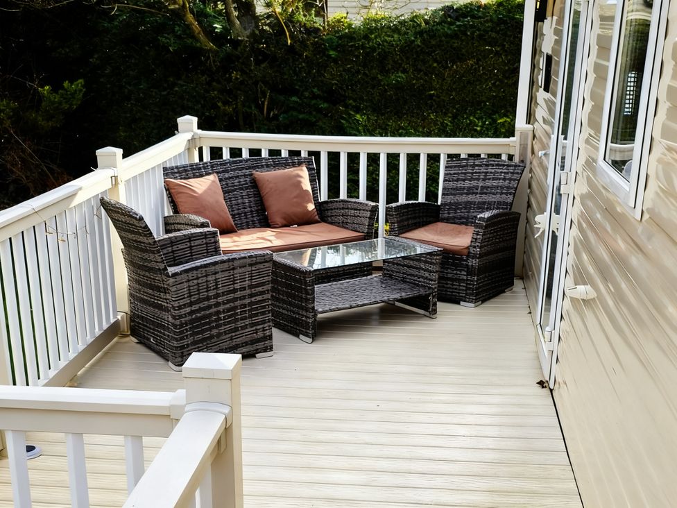A deck with seating and a table at D&T Caravan Hire Southview Holiday Park Skegness
