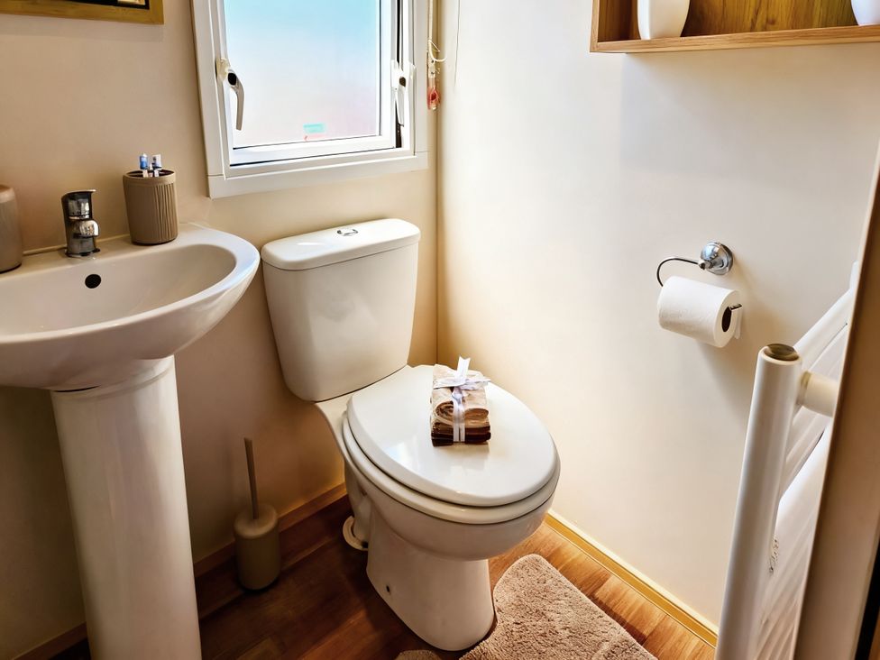 A bathroom with a sink and toilet at D&T Caravan Hire Southview Holiday Park Skegness