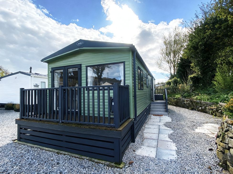 A cabin with a deck and steps at Coworth Deluxe Cabin with Garden