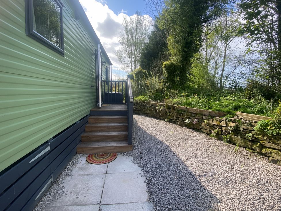 An outdoor pathway with steps and plants at Coworth Deluxe Cabin with Garden
