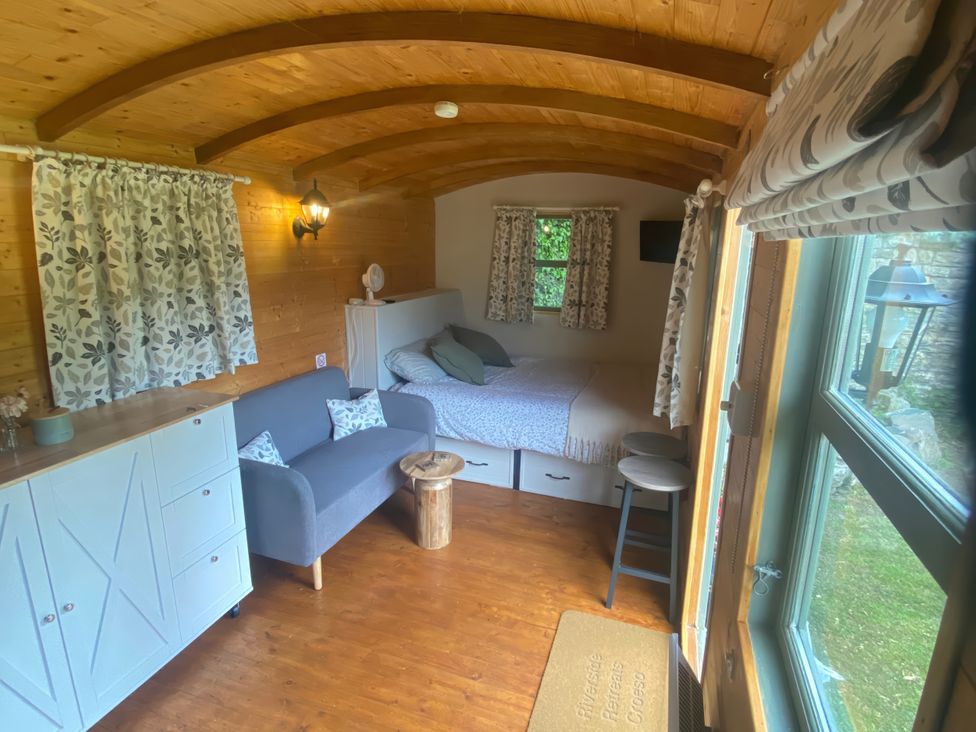 A bedroom with a bed and couch at Cozy Cabin Retreat in Newtown