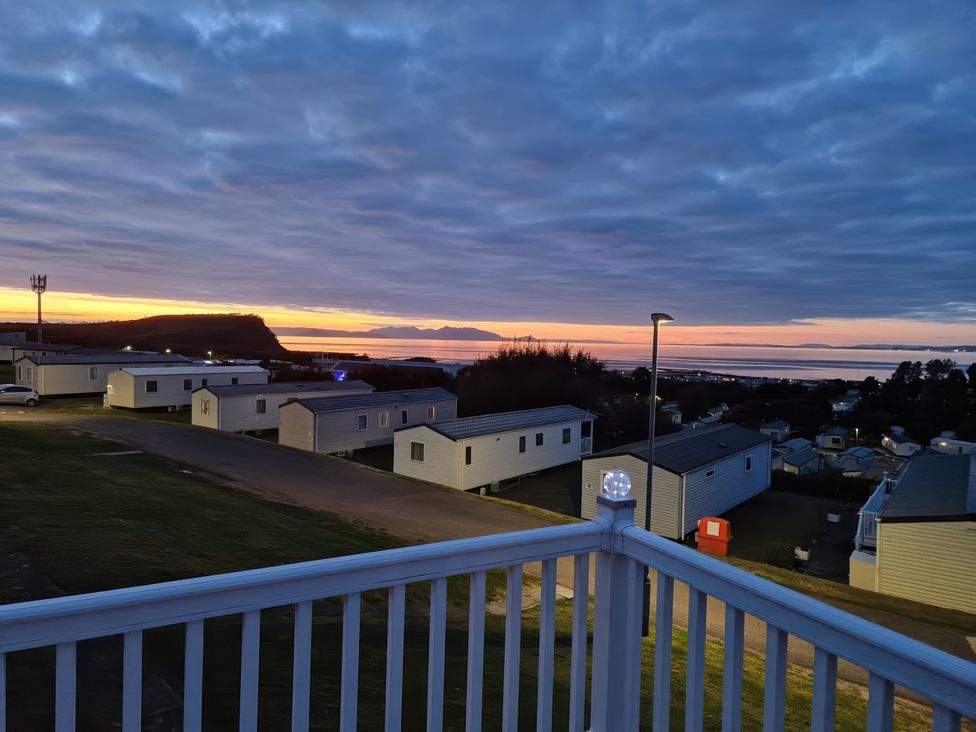 Views of caravans and sea at sunset at Caravan Sleeps 6 with Sea Views and Parking in Ayr