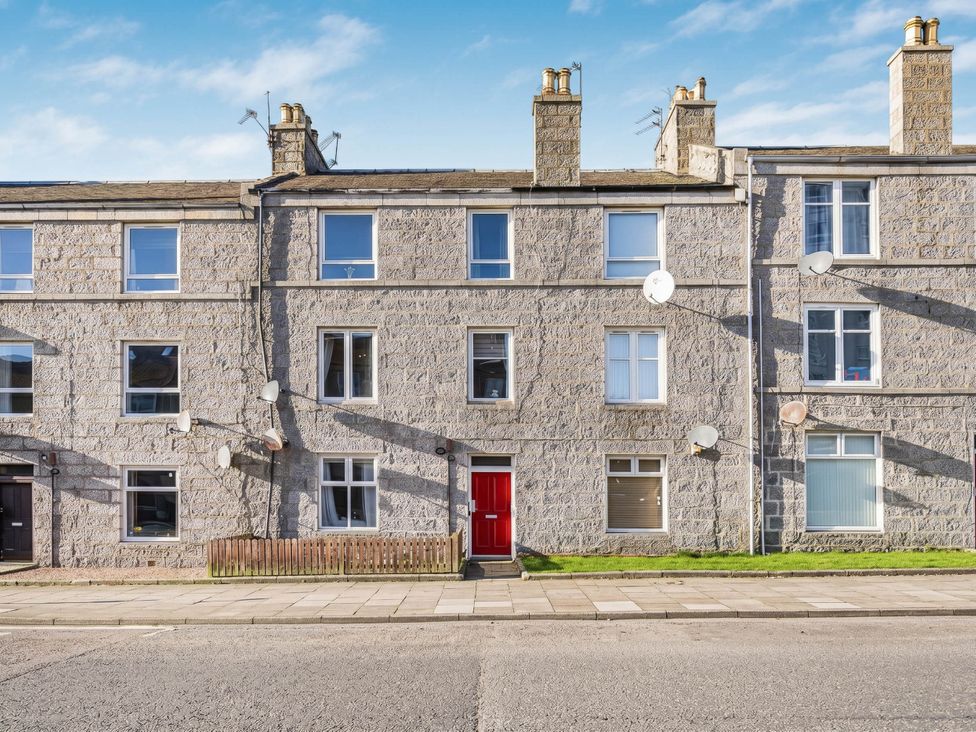 A building with multiple windows and a red door at Central Aberdeen flat Holburn St workspace parking Aberdeen