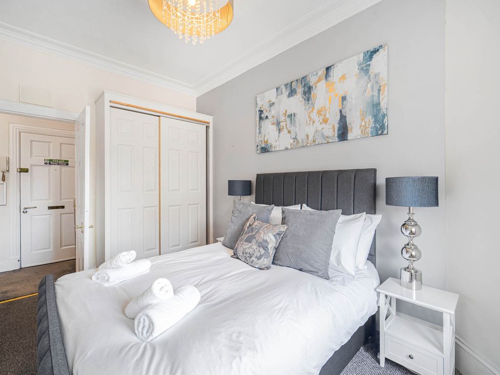 A bedroom with a bed and lamps at Central Aberdeen flat Holburn St workspace parking, Aberdeen