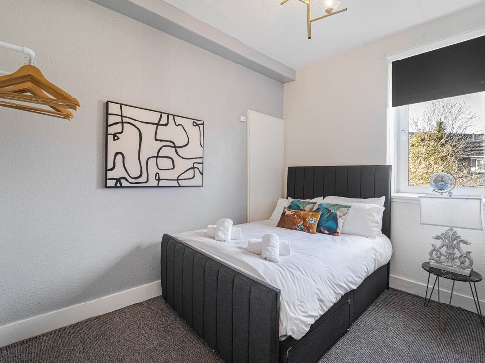 A bedroom with a bed and artwork at Central Aberdeen flat Holburn St workspace parking in Aberdeen
