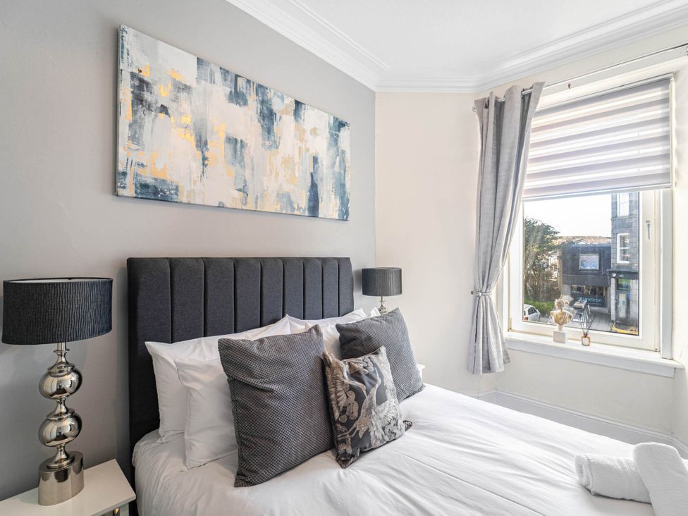 A bedroom with a bed and lamps at Central Aberdeen flat Holburn St workspace parking, Aberdeen
