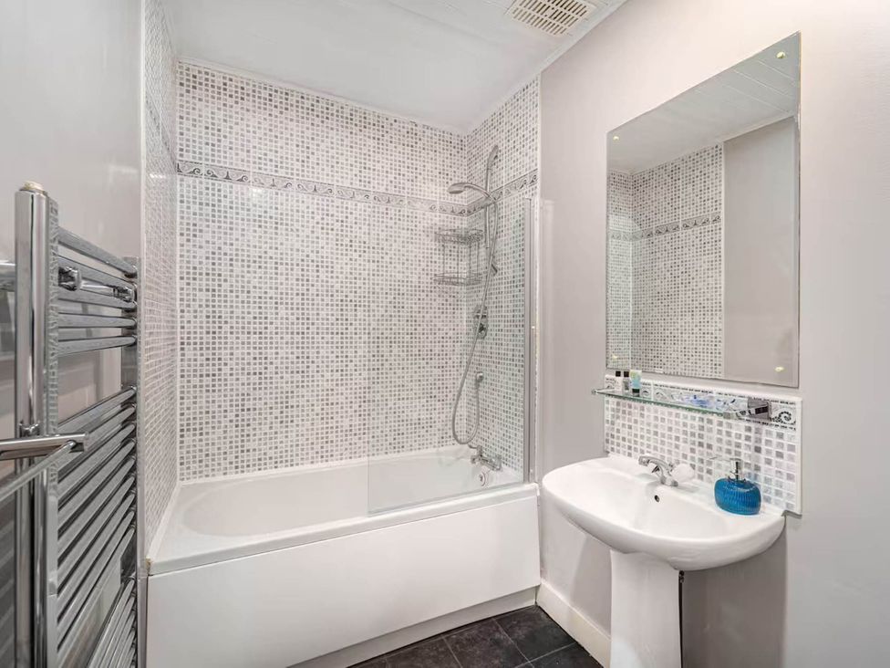 A bathroom with a bathtub and shower at Central Aberdeen flat Holburn St workspace parking Aberdeen