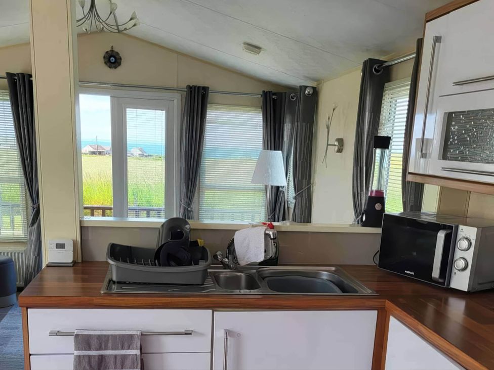 A kitchen with a sink and dish rack at BandR Turnberry Escape Scotland Girvan