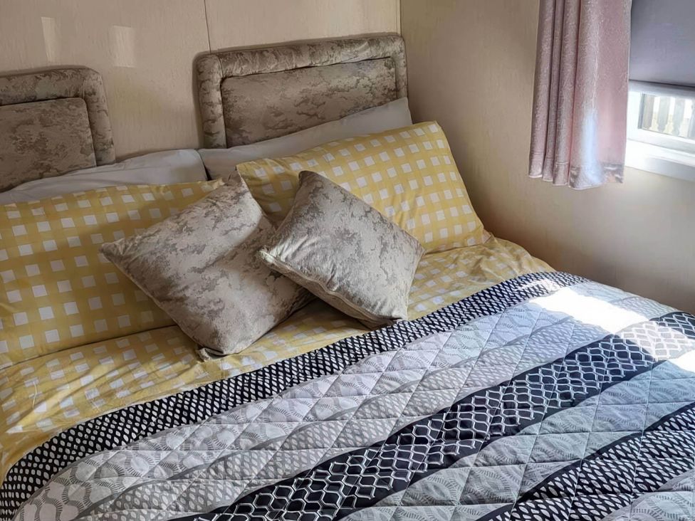 A bedroom with a bed and pillows at BandR Turnberry Escape Scotland in Girvan
