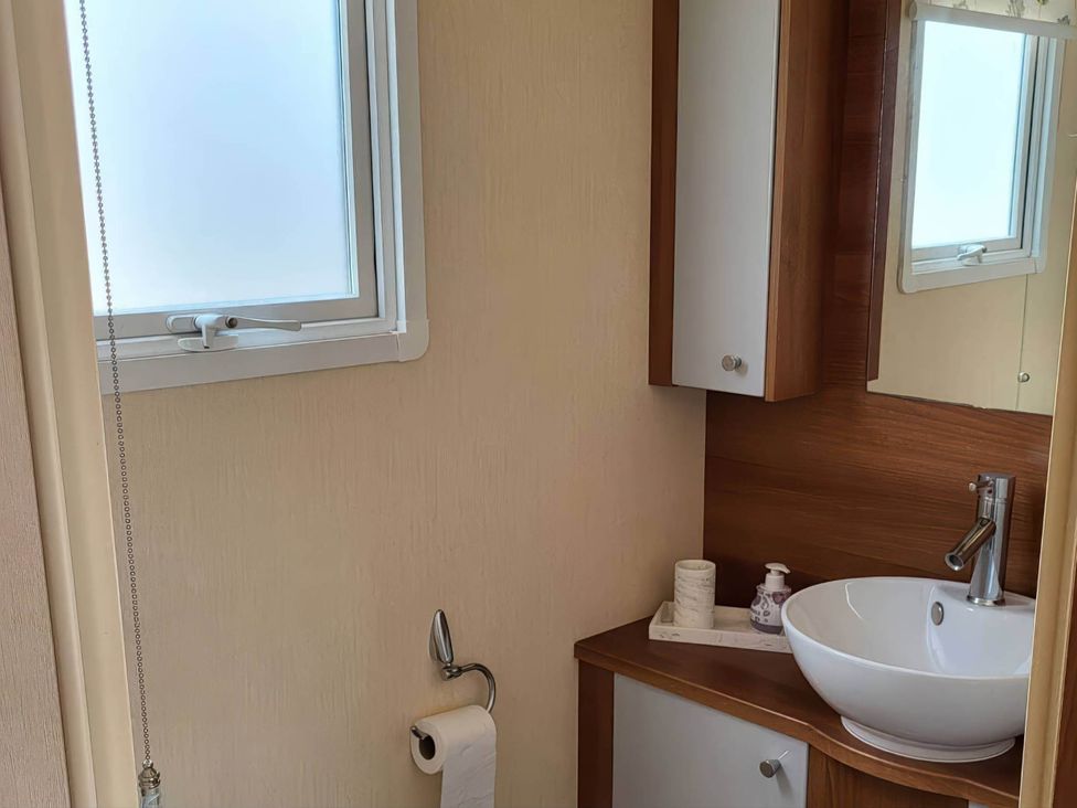 A bathroom with a sink and cabinet at BandR Turnberry Escape Scotland in Girvan