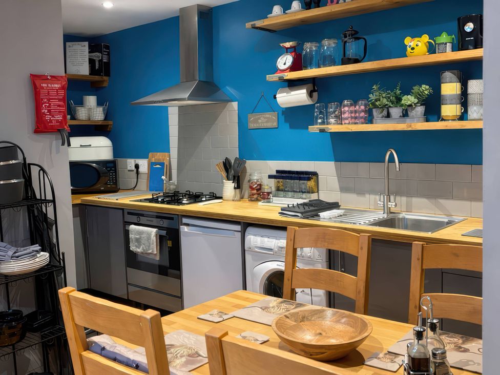 A kitchen with appliances and wooden furniture at Rural 2 double bedrooms Barn Mill Meece near Eccleshall