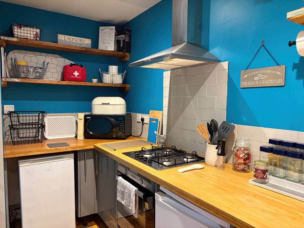 A kitchen with a gas stove and microwave at Rural 2 double bedrooms Barn Mill Meece near Eccleshall