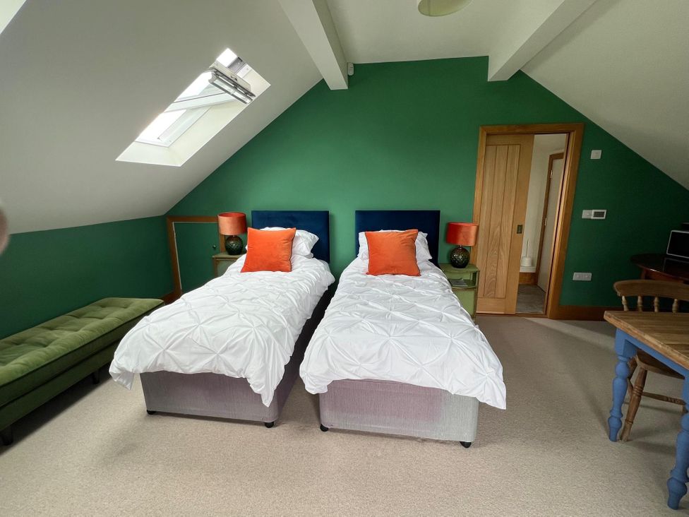 A bedroom with twin beds, a chair, and a table at 2 Guests Studio - Free Parking - Stunning Views near Bruton