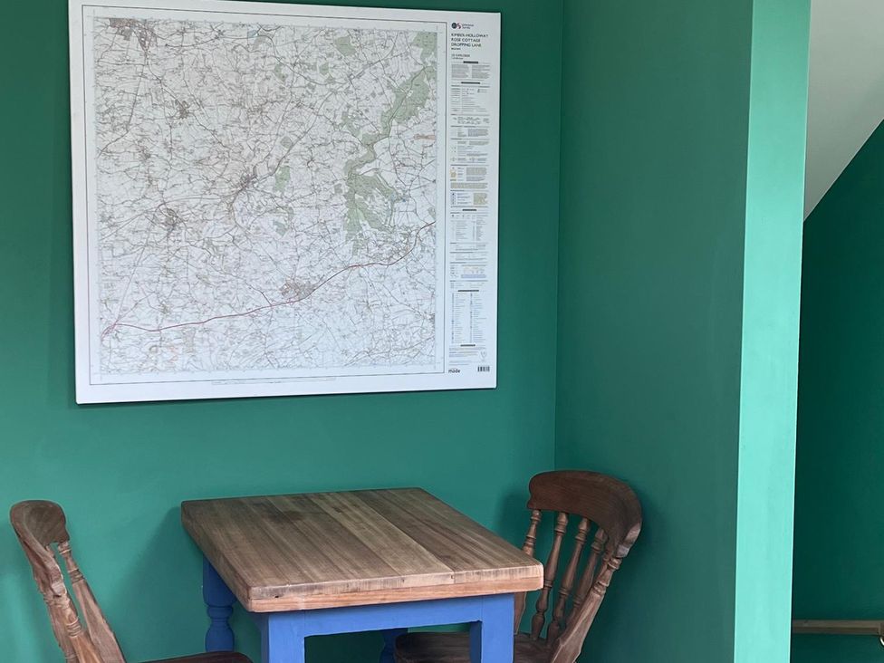A dining area with a table and chairs and a map on the wall at 2 Guests Studio - Free Parking - Stunning Views near Bruton