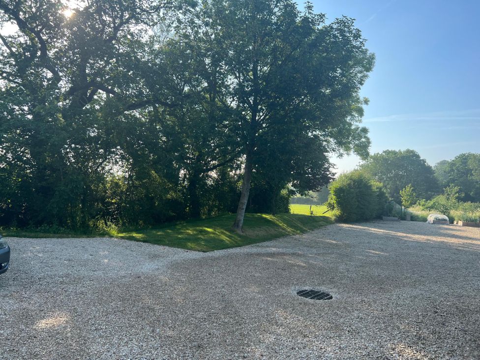 An outdoor space with trees and gravel area at 2 Guests Studio - Free Parking - Stunning Views near Bruton