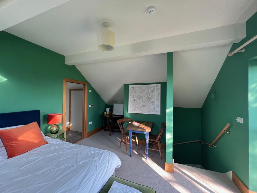 A bedroom with a bed and desk at 2 Guests Studio - Free Parking - Stunning Views near Bruton