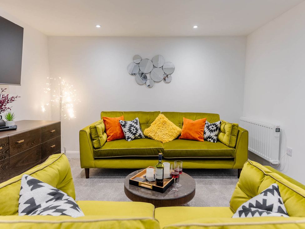 A living room with a sofa and coffee table at Cosy 2-Bed Apartment in Nettleham