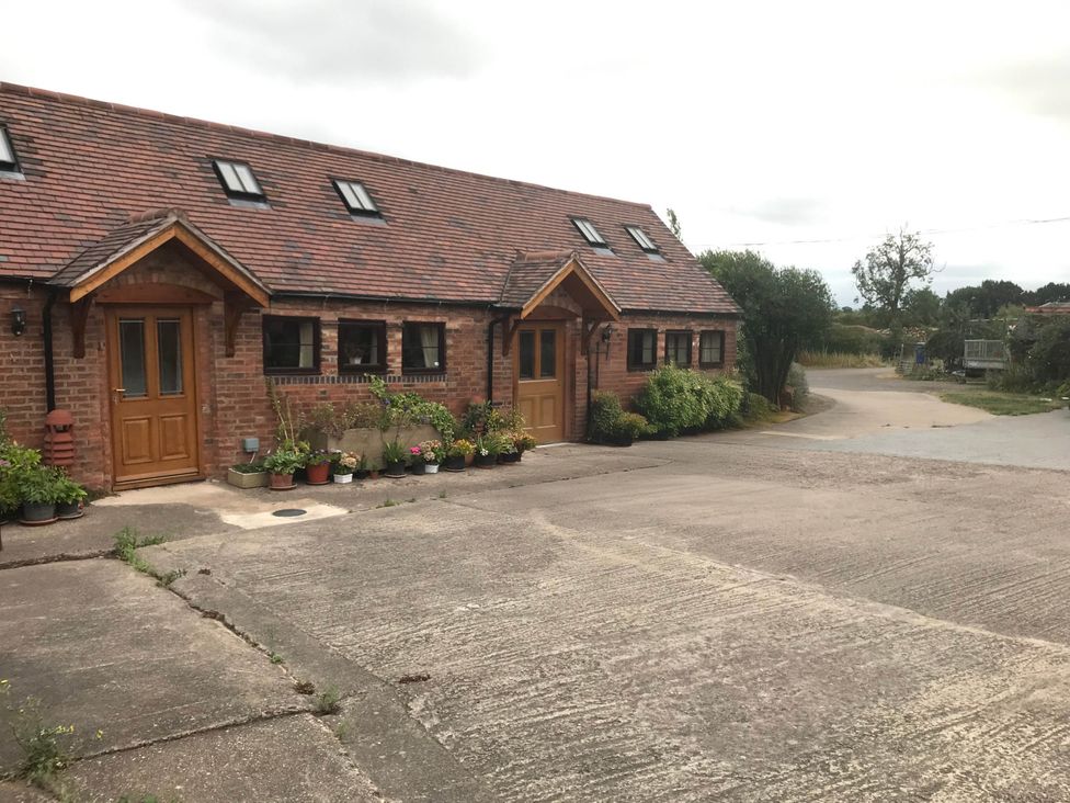 A house exterior with doors and windows at Cottage in Nuneaton - Sleeps 2 - Parking - Garden Higham-on-the-Hill near Nuneaton