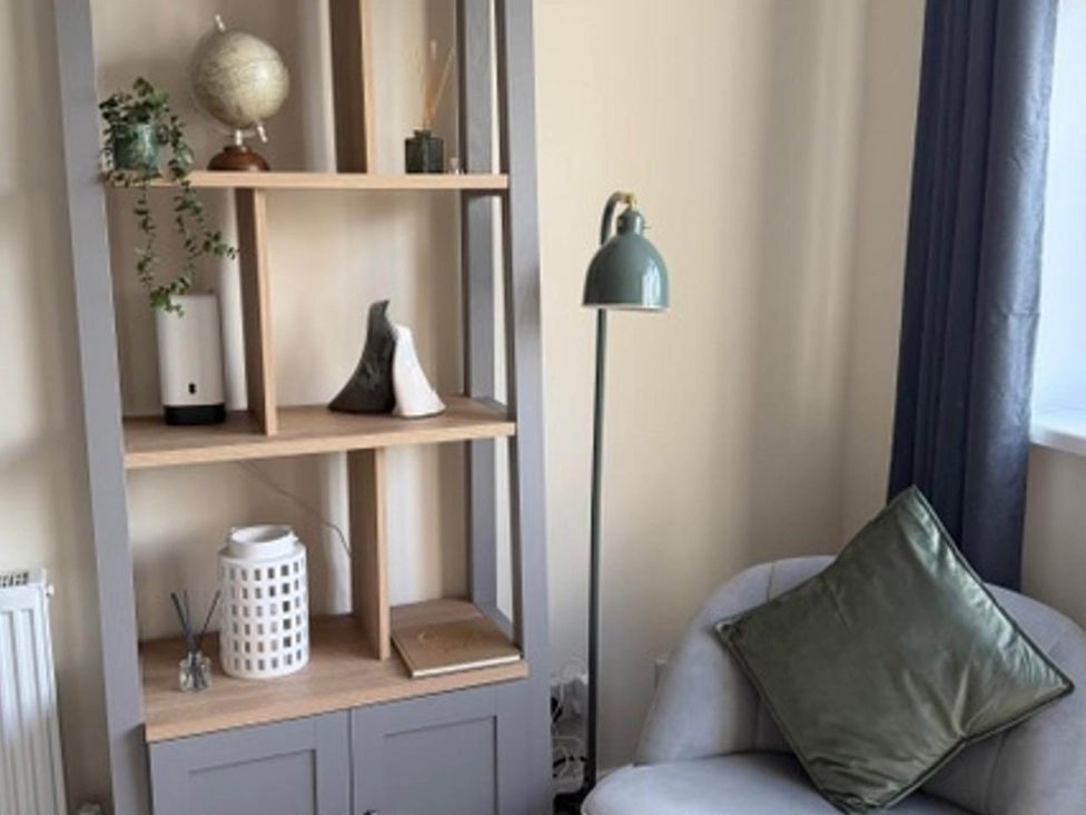 A living room with a bookshelf and chair at Meriden Apartment - Sleeps 7 - Near Nec, Parking Meriden