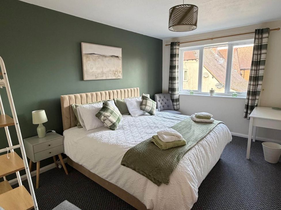 A bedroom with a bed and nightstand at Meriden Apartment - Sleeps 7 - Near Nec, Parking in Meriden