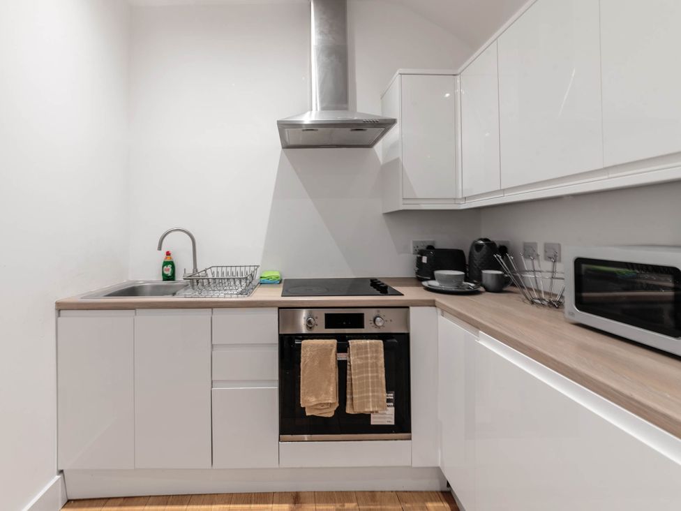 A kitchen with storage space, sink and appliances at Central - Sleeps 2 - Near Transport - Parking, Maidenhead