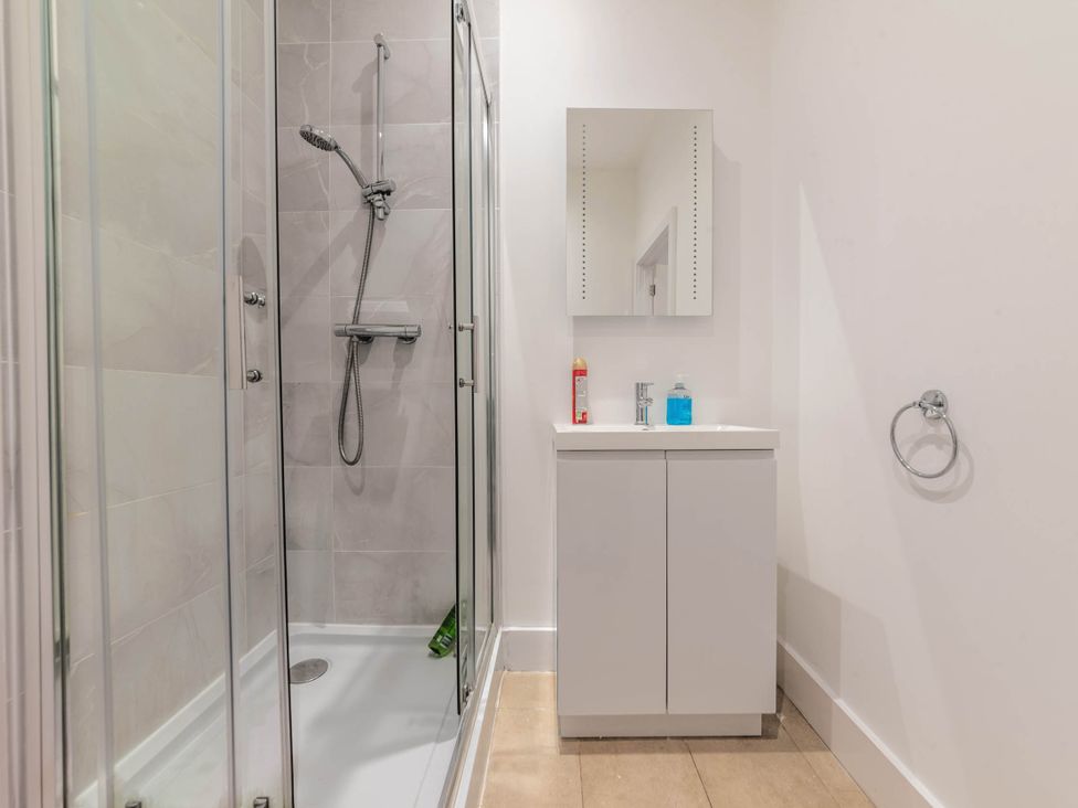 A bathroom featuring a shower and a sink with cabinet at Central - Sleeps 2 - Near Transport - Parking in Maidenhead