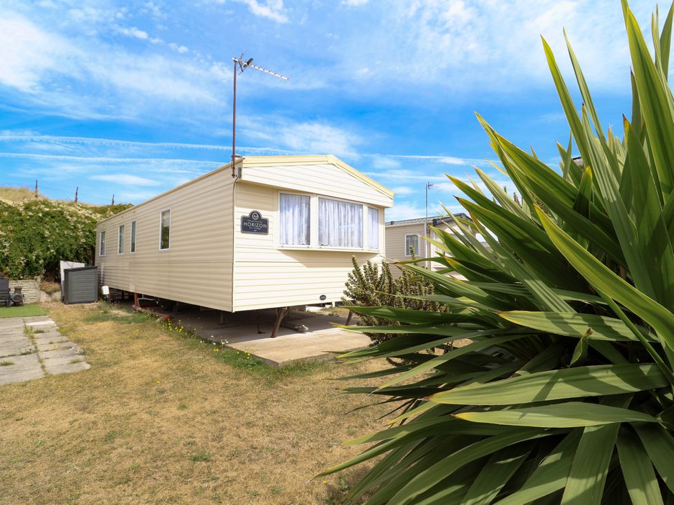 A mobile home with a satellite dish and a plant at Plot 594 Prestatyn