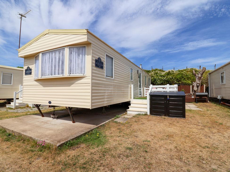A mobile home with steps and an outdoor storage unit at Plot 594 Prestatyn