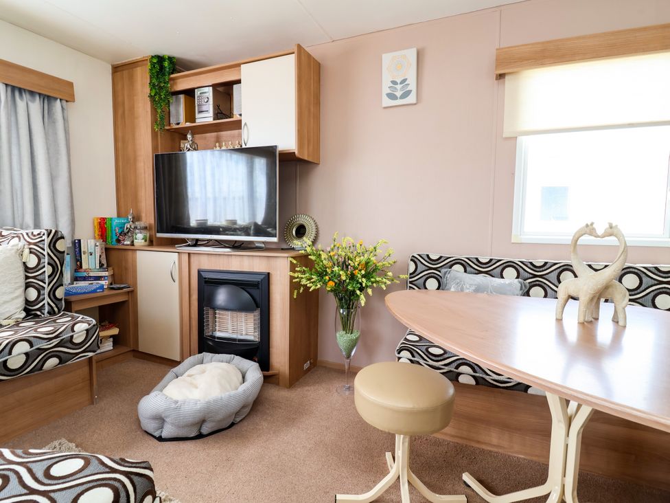 A living room with a sofa and television at Plot 594 in Prestatyn