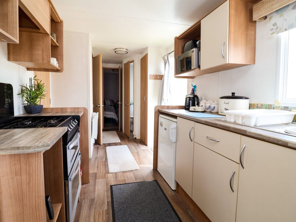 A kitchen with appliances and cabinetry at Plot 594 in Prestatyn