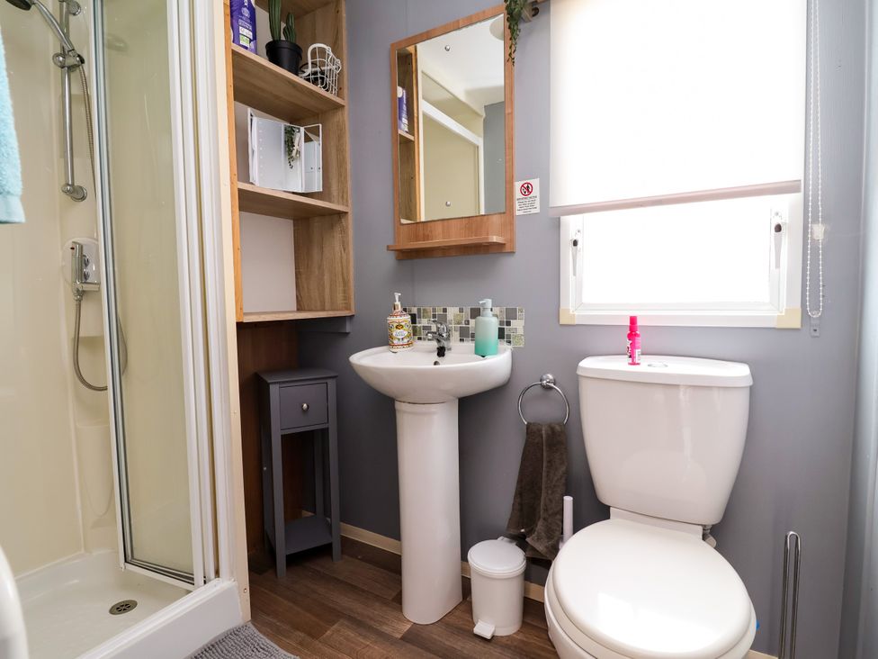 A bathroom with shower, sink and toilet at Plot 594 Prestatyn